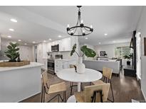 Bright, modern kitchen with stainless steel appliances and open layout to the dining area and living room at 1661 Red Fox Pl, Highlands Ranch, CO 80126