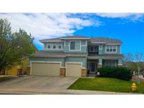 Charming two-story home with a three car garage, manicured lawn, and classic architectural details at 3590 S Malaya St, Aurora, CO 80013
