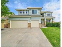 Charming two-story home boasts a well-manicured lawn and a convenient two-car garage at 3590 S Malaya St, Aurora, CO 80013