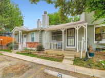 Charming townhome with a cozy front porch and well-maintained landscaping at 8236 Washington St # 29, Denver, CO 80229