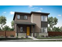 Charming two-story home with a welcoming yellow door and a beautifully landscaped front yard at 5760 N Jebel Way, Aurora, CO 80019