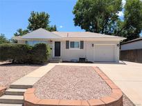 Charming single-story home featuring a well-maintained yard and attached garage on a sunny day at 420 E 104Th Pl, Northglenn, CO 80233