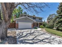 Charming two-story home featuring a well-maintained front yard, driveway, and attached two-car garage at 8696 E Easter Ave, Centennial, CO 80112