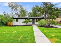 Charming single-story home with a freshly manicured lawn and inviting walkway at 6526 S Elmwood St, Littleton, CO 80120