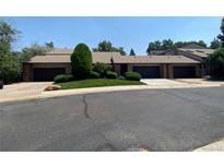 Inviting exterior view of townhouse featuring attached garages, lush lawn, and mature trees at 540 S Forest St # A2, Denver, CO 80246