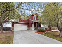 Charming two-story home with a well-manicured lawn and inviting front porch at 6202 Ralston St, Frederick, CO 80530
