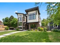 Contemporary home with unique architectural design, brick accents, and manicured lawn at 1500 S Elizabeth St, Denver, CO 80210