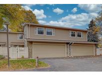 Two-story townhome features a two-car garage, siding exterior, and lovely landscaping at 2752 S Heather Gardens Way, Aurora, CO 80014
