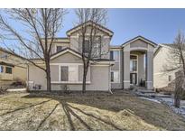 Charming two-story home featuring a manicured front yard, stucco exterior, and mature trees at 19406 E Maplewood Pl, Aurora, CO 80016