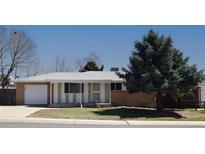 Charming single-story home featuring a well-maintained front yard and an attached garage at 8750 Rutgers St, Westminster, CO 80031