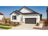 Charming home featuring a two-car garage, neutral colors, and a well-manicured front yard at 9192 Telluride Ct, Commerce City, CO 80022