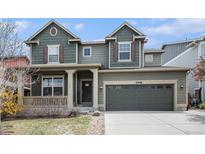 Charming two-story home with a covered front porch, well-maintained lawn, and two-car garage at 2996 Skyward Way, Castle Rock, CO 80109