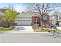 Charming single-Gathering home with a well-manicured front yard and an attached two-car garage at 7141 S Versailles St, Aurora, CO 80016