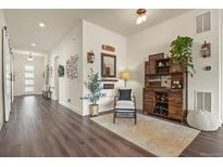 Stylish entryway with wood floors, decor accents, and an inviting bar area at 328 Simmental Loop, Castle Rock, CO 80104