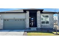 Beautiful single-Gathering home boasts stone accents, a modern design, and a two-car garage at 328 Simmental Loop, Castle Rock, CO 80104