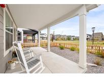 Inviting covered front porch with rocking chairs, offering a relaxing outdoor space at 129 Mesa Way, Superior, CO 80027