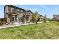 Attractive townhouse exteriors with well-manicured lawns and landscaping in a row of homes at 1273 S Dallas Ct, Denver, CO 80247
