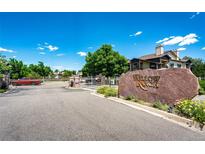 Community entrance features a large stone sign with 'Willow Ranch' and gated entry on a bright, sunny day at 5439 S Dover St # 101, Littleton, CO 80123