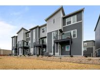 Modern townhome exterior featuring gray siding, black accents, and small balconies at 2736 W 68Th Ave, Denver, CO 80221