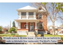 Charming two-story brick home boasts a welcoming front porch and meticulously maintained landscaping at 3905 Tejon St, Denver, CO 80211