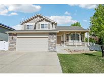 Charming two-story home with a covered porch and well-maintained lawn at 16304 10Th St, Mead, CO 80542