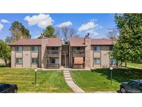 Two-story condo building with stone accents and well-maintained lawn offers a charming curb appeal at 1792 S Pitkin Cir # B, Aurora, CO 80017