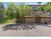 Townhome boasts brick accents, attached two-car garage and mature landscaping at 6825 S Webster St # A, Littleton, CO 80128