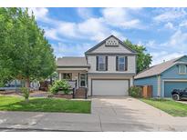 Charming two-story home with a well-manicured front yard and an attached two-car garage at 5741 E 120Th Pl, Brighton, CO 80602