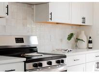 Close up of a kitchen with new stainless steel oven and backsplash at 930 S Lowell Blvd, Denver, CO 80219