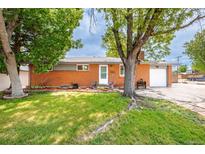 Charming brick home with mature trees and a well-manicured lawn offering great curb appeal at 6598 S Logan St, Centennial, CO 80121
