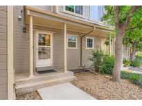 Inviting front porch featuring a concrete path leading to the front door of the two-story home at 11155 W 17Th Ave # 103, Lakewood, CO 80215