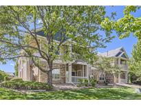 Beautiful townhome with stone accents, a manicured lawn, mature trees and a covered porch to enjoy the view at 3375 Boulder Cir # 204, Broomfield, CO 80023