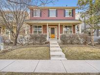 Charming two-story home boasts a cozy front porch with decorative accents and inviting curb appeal at 8367 Devinney St, Arvada, CO 80005