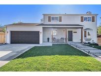 Charming two-story home featuring a well-manicured lawn, covered porch, and a two-car garage at 5872 Taft St, Arvada, CO 80004