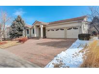 Spacious home with a three-car garage and well-maintained brick driveway in a friendly neighborhood at 6328 S Ouray Way, Aurora, CO 80016