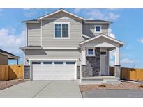 Charming two-story home showcasing a well-manicured lawn, attached two-car garage, and neutral color palette at 17945 E 94Th Ave, Commerce City, CO 80022