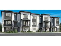 Modern townhome showcasing a sleek, contemporary design with multiple units and well-manicured landscaping at 646 Saddle Dr, Erie, CO 80516