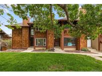 Charming townhomes with cedar siding, lush front lawns and mature shade trees at 1264 S Crystal Way, Aurora, CO 80012