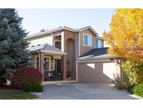 Charming two-story home featuring brick accents, a welcoming front porch, and well-maintained landscaping at 10535 Garfield St, Thornton, CO 80233