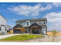 Stunning two-story home boasts a modern design, professional landscaping, and attached two-car garage at 39417 Stockton Cir, Elizabeth, CO 80107