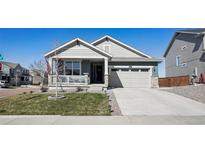 Charming single-Gathering home featuring a well-maintained lawn, covered porch, and a two-car garage at 965 Peach Leaf Ln, Elizabeth, CO 80107
