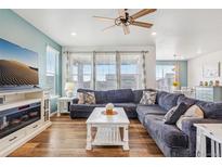 Comfortable living room featuring a plush sectional sofa and abundant natural light at 965 Peach Leaf Ln, Elizabeth, CO 80107