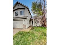 Charming two-story home featuring a well-maintained lawn and an attached two-car garage at 5521 Spruce Ave, Castle Rock, CO 80104