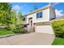 Charming two-story home with a well-maintained yard and attached two-car garage at 2251 Cliffrose Ln, Louisville, CO 80027