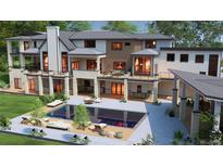 An outdoor living space featuring a gorgeous pool, patio, lush greenery, and a multi-level home with stone accents at 1757 Whistlepig Ln, Broomfield, CO 80020