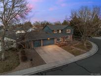 Aerial view of home showcasing its brick and siding exterior, driveway, and landscaping at 2090 S Gray Dr, Lakewood, CO 80227