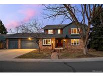 Charming two-story brick home featuring a landscaped yard and inviting front entrance at 2090 S Gray Dr, Lakewood, CO 80227