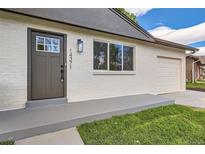 Charming home exterior with modern front door and attached one-car garage at 14317 Olmsted Dr, Denver, CO 80239