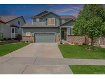 Charming two-story home with a lush lawn, two-car garage and meticulous landscaping at 16671 E Prairie Goat Ave, Parker, CO 80134