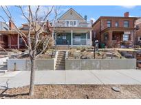 Charming blue two-story home with a covered porch and upper-level balcony, offering classic curb appeal at 16 N Pennsylvania St, Denver, CO 80203